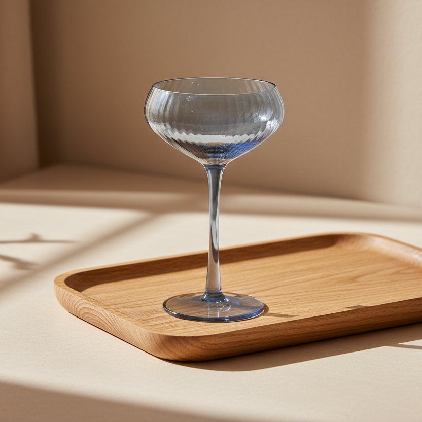 Blue glass cocktail glass on a white background