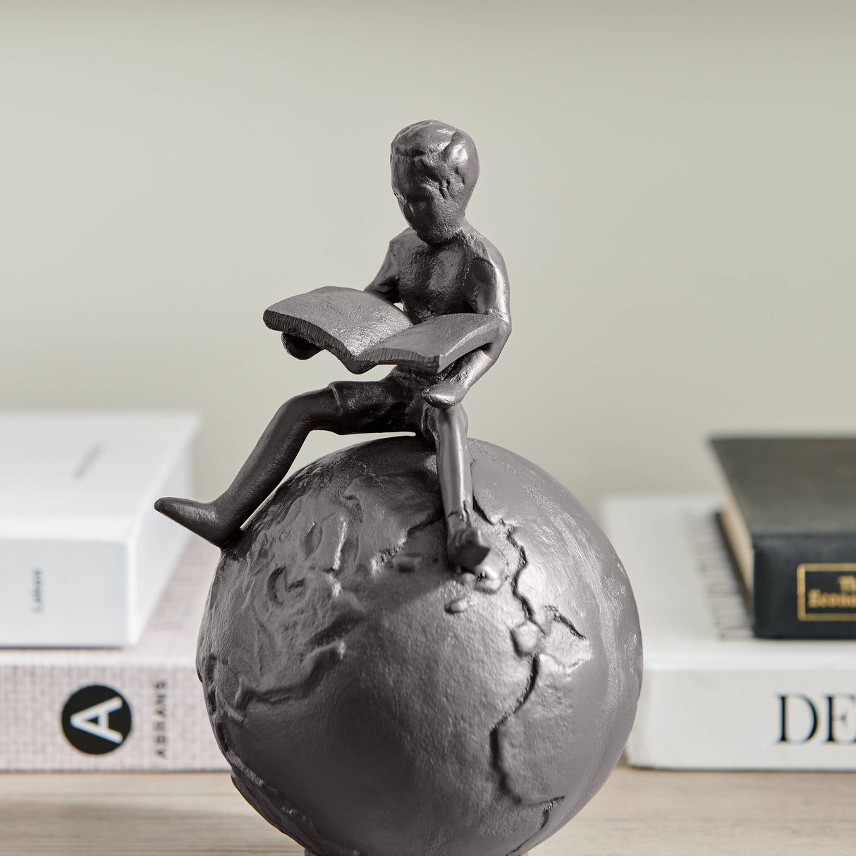Brown Cast Iron Boy Reading on Globe Sculpture