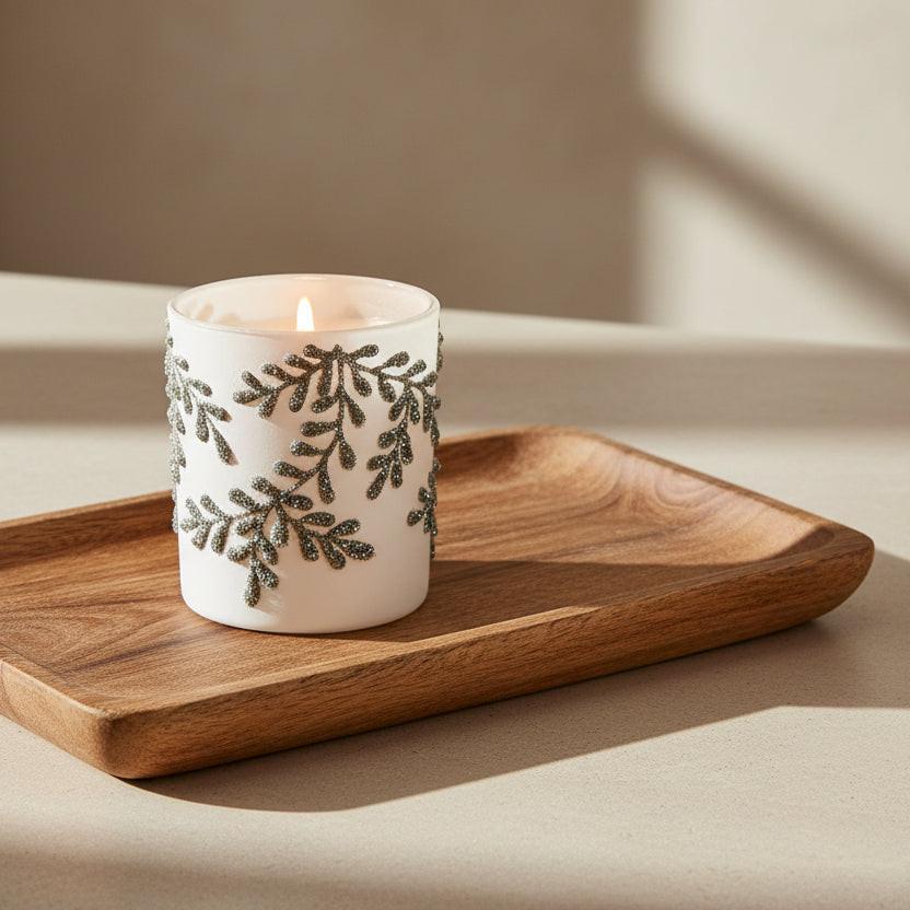 White candle holder with black leaf pattern on a white background