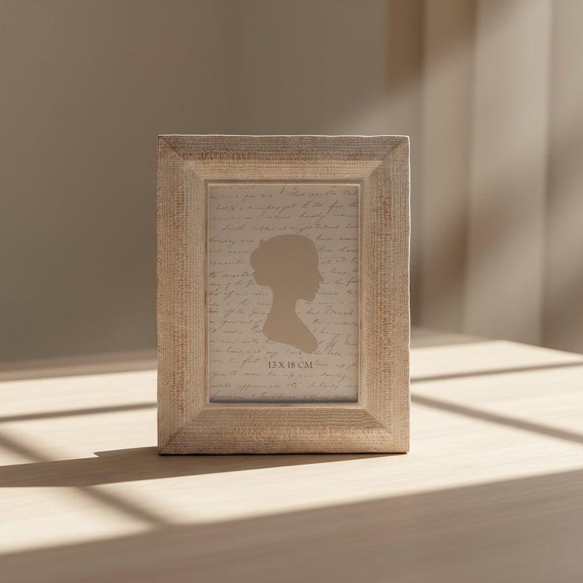 Wooden picture frame with a silhouette and text on a white background