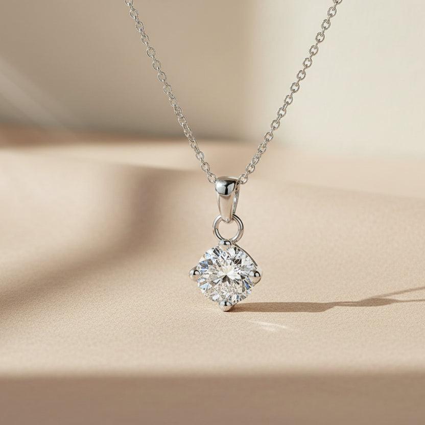 Diamond pendant on a chain against a white background