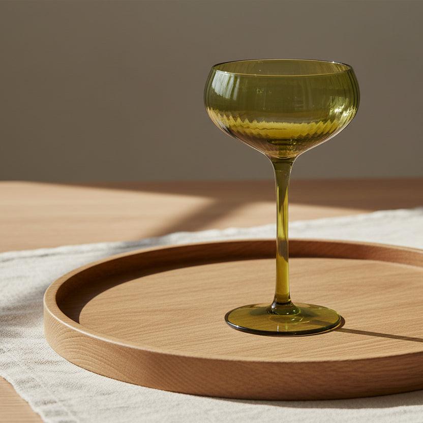 Green glass coupe on a white background