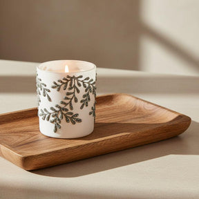 White candle holder with black leaf pattern on a white background