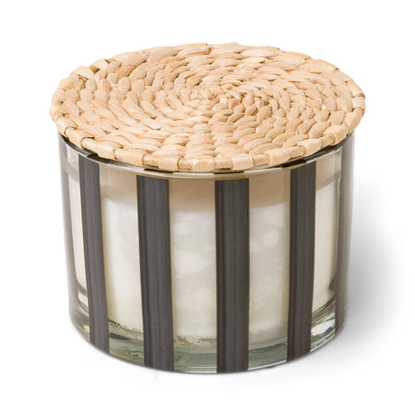 Elegant striped luxury candle casting a warm, inviting glow in an upscale setting