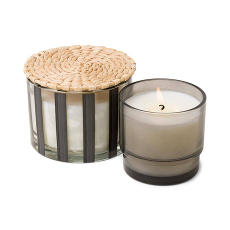 Elegant striped luxury candle casting a warm, inviting glow in an upscale setting