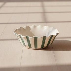 Ceramic dish with 'bon appetit' text on a white background