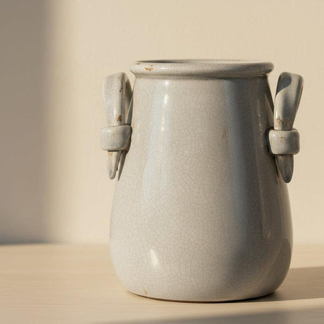 Grey ceramic vase with handles on a white background