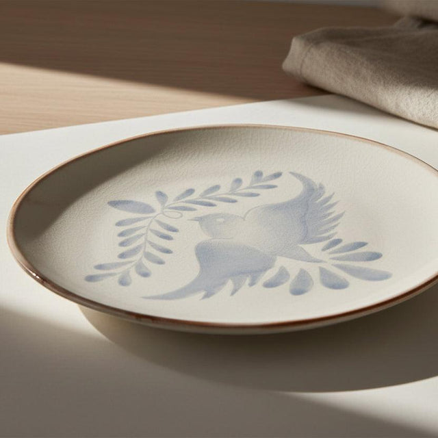 Ceramic plate with blue bird design on a white background