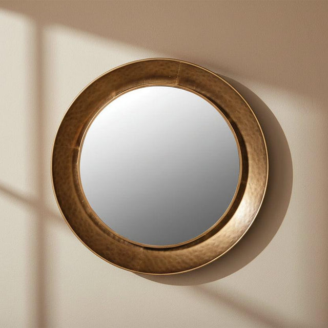 Round mirror with a bronze frame on a white background