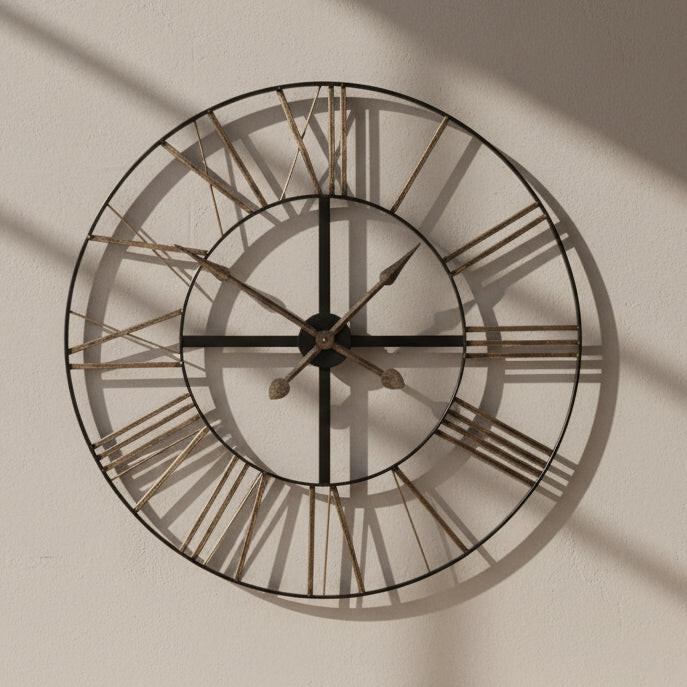 Large round wall clock with metallic Roman numeral markers on a white background