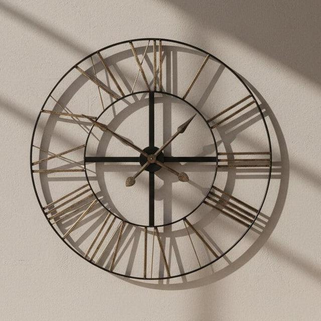 Large round wall clock with metallic Roman numeral markers on a white background