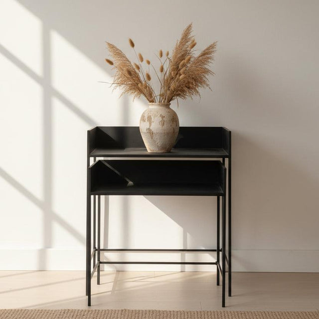 Set of two black metal bar stools on a white background