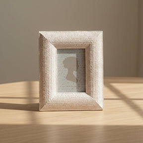 Decorative photo frame with silhouette design on a textured fabric background
