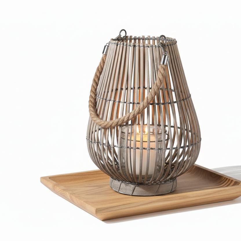 Woven rattan lantern with a rope handle on a white background