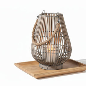Woven rattan lantern with a rope handle on a white background
