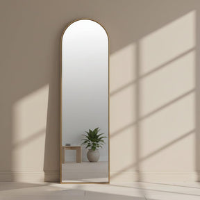 Arched mirror with a gold frame on a white background