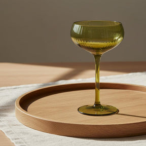 Green glass coupe on a white background
