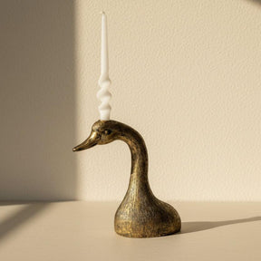 Bronze goose-shaped candle holder on a white background