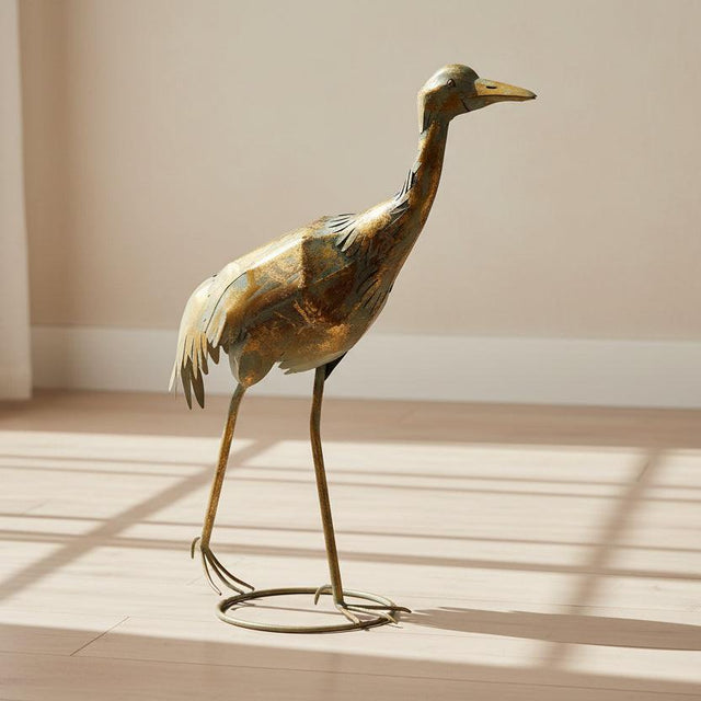 Decorative metal crane sculpture on a white background