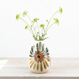 Ceramic vase with floral design on a wooden surface