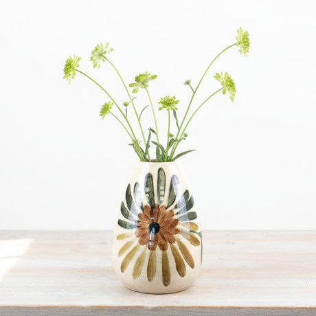 Ceramic vase with floral design on a wooden surface