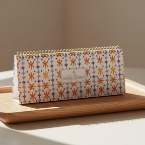 Patterned planner with 'The Weekly Planner' branding on a white background