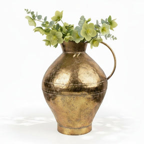 Gold pitcher on a white background